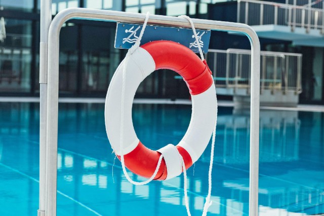 A life preserver hanging by a pool