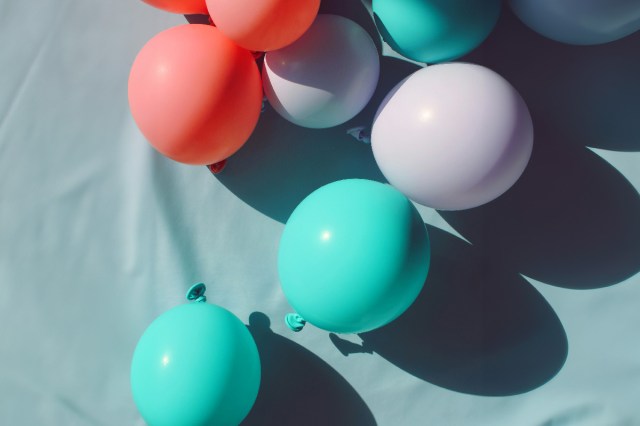 Different colored balloons on a blue background