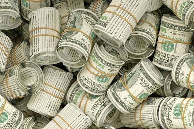 A pile of rolled up dollar bills