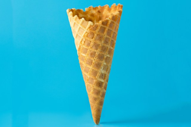 An ice cream waffle cone on a blue background