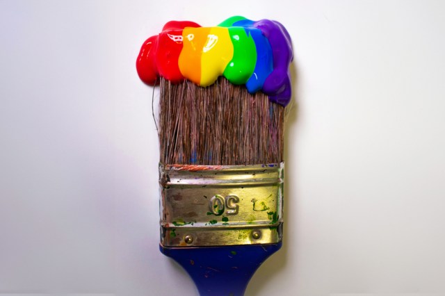 A paint brush with many different paint colors