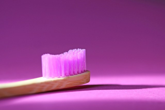 A toothbrush on a purple background