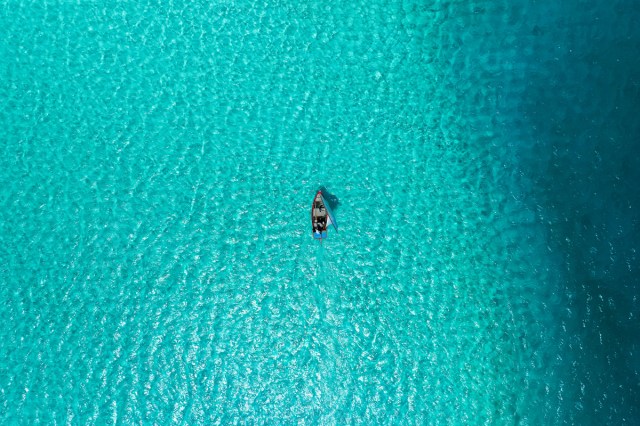 An aerial view of a boat sailing in the water