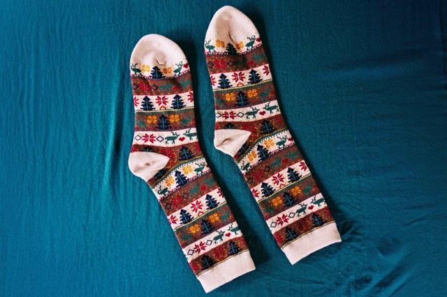 A pair of socks laid out on a blue background 