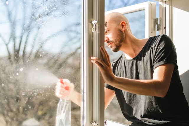 Man cleaning glass window