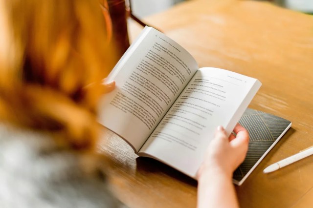 A woman holding a book open