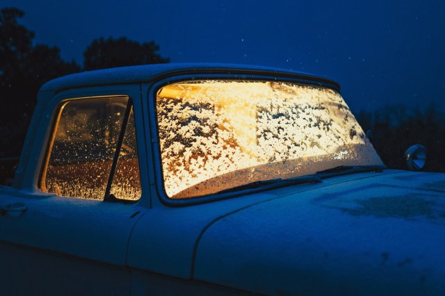 A truck with snow on the windshield