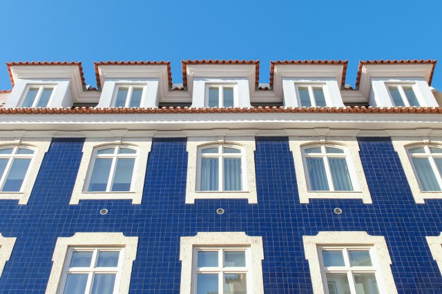 A blue building with white windows on a blue background