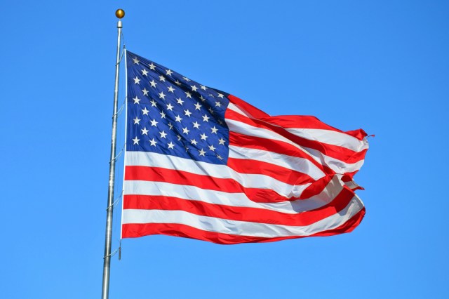 The American flag with the sky in the background