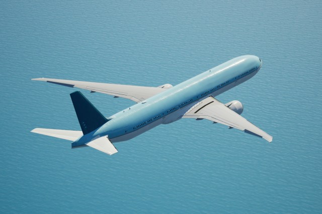 A blue and white airplane flying in the sky 