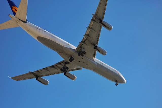 A plane taking off seen from below