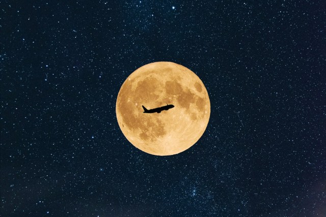 A plane flying past the moon