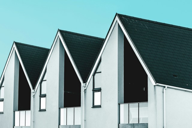 The tops of houses on a blue sky background